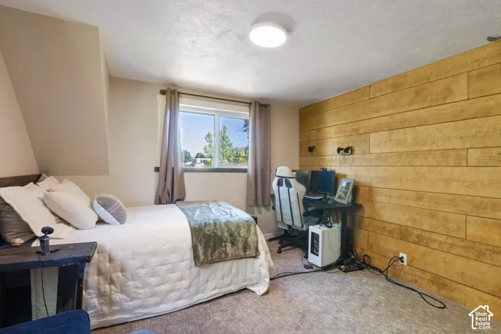 Accent wall featuring horizontal wood planks, a window with a white frame, and a flush-mount ceiling light