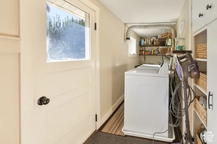 Utility area featuring a glass-paneled door, built-in shelving, and a small window