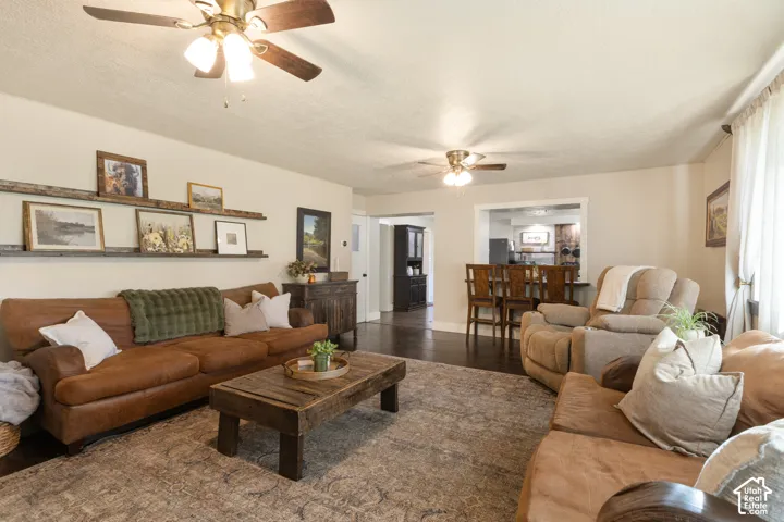 Recessed ceiling fans, wood-finish flooring, built-in shelving, and an open concept layout create a functional living space