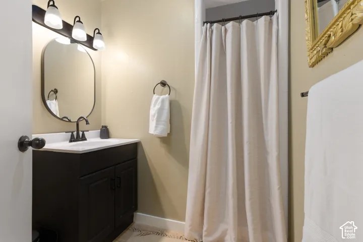 Black vanity with a white countertop and a black faucet