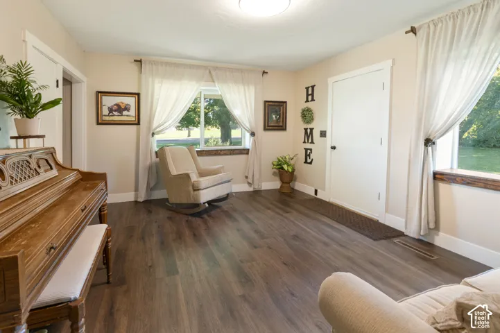 Wood-finish flooring, light-toned walls, and white trim throughout