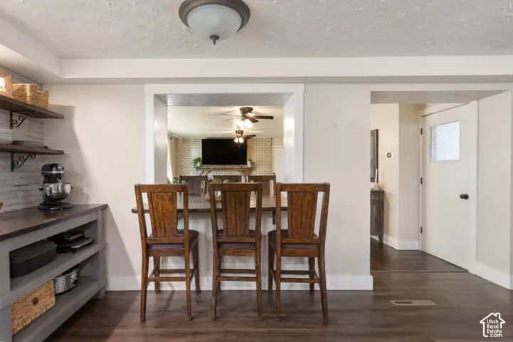 Wood-finish flooring, built-in shelving, white walls, and a white interior door with frosted glass panel