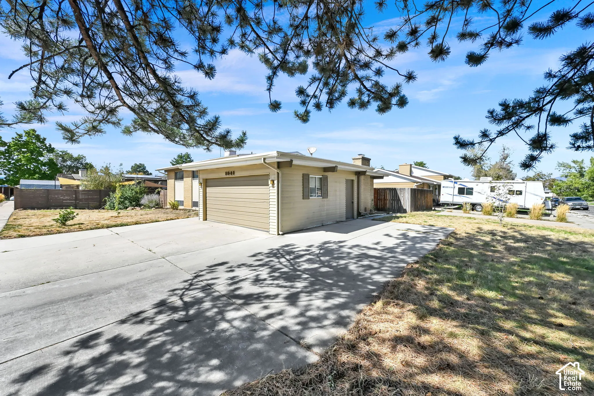 Single-level exterior featuring siding and a horizontal garage door