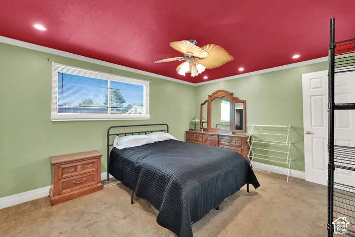 Recessed lighting, ceiling fan, crown molding, paneled door, and a sliding window with horizontal blinds