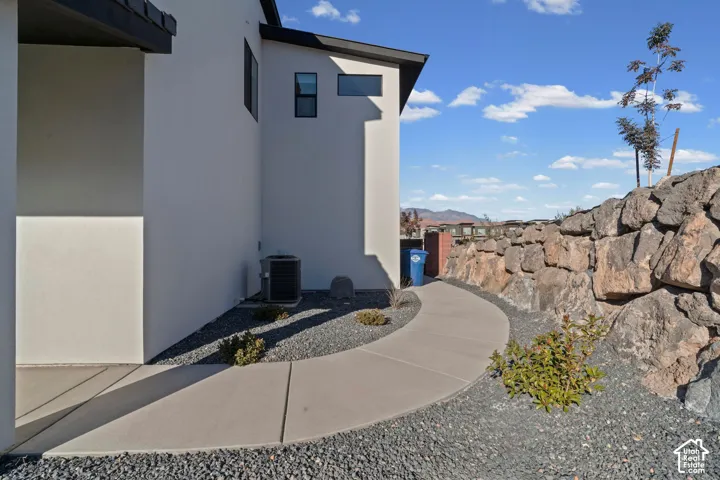 Contemporary exterior architecture with clean lines and stucco finish, accented by dark window frames