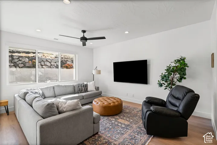 Recessed lighting with a ceiling fan, light wood-finish flooring, and white baseboards