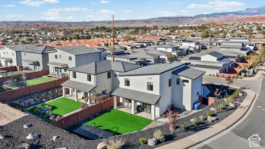 Modern architectural design with light-colored stucco exterior and dark-toned roofing