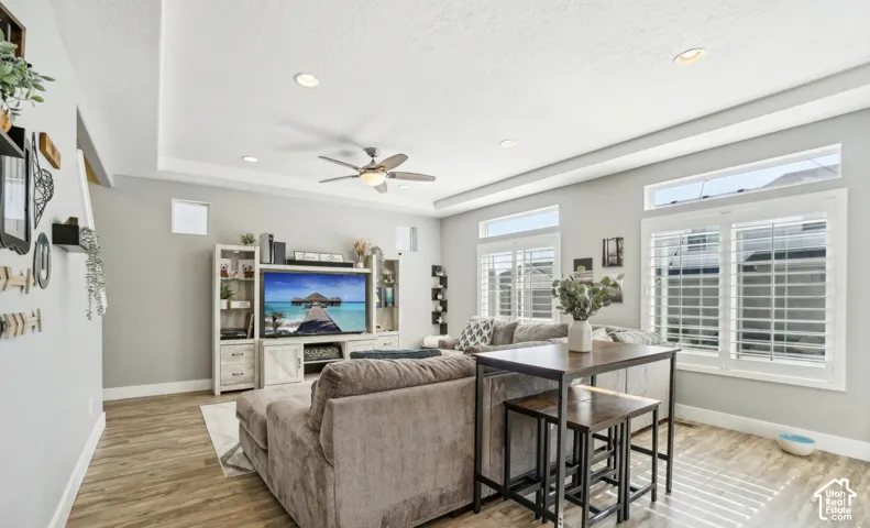 Recessed lighting and ceiling fan complement the tray ceiling