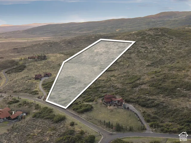 Expansive land parcel featuring natural terrain and distant mountainous scenery