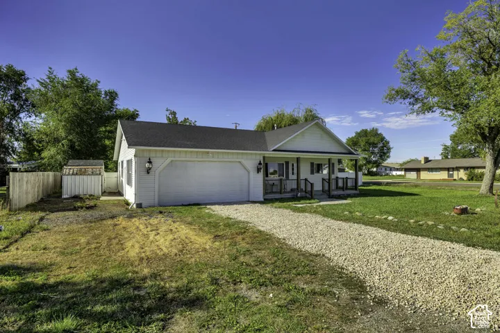 Charming ranch-style home with a two-car attached garage, front-covered porch entry, and gable roofline