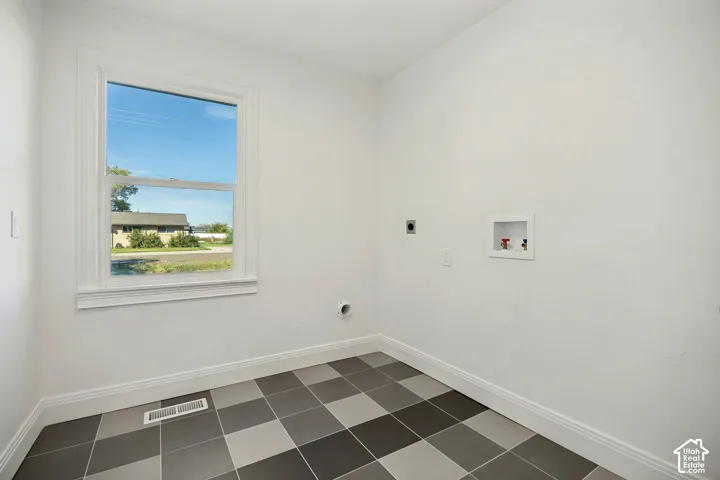 Room featuring a checkerboard tile floor, a single window, and white walls