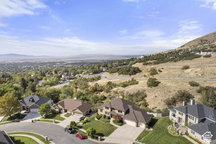 Mountainous terrain backdrop with residential properties and expansive natural scenery