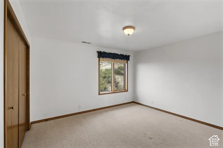 Neutral-toned carpeting with wood-finish trim