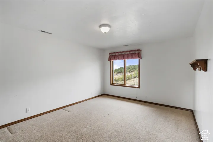 White painted walls with wood-trim window and baseboards