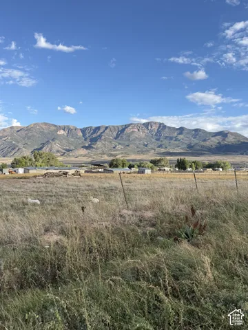 Expansive land parcel with surrounding mountain range