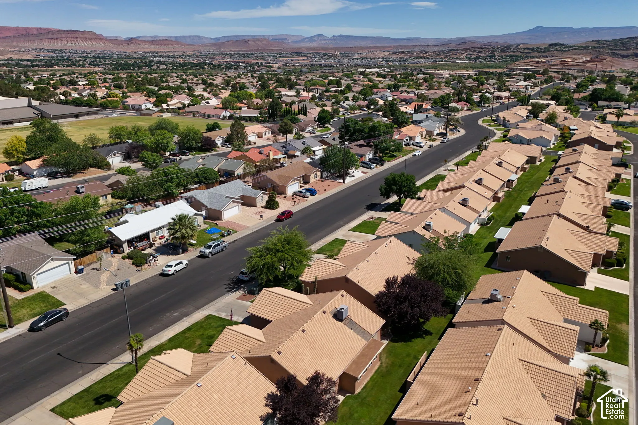 Established residential community featuring well-planned single-family homes with tan tile roofing, mature landscaping, and tree-lined streets