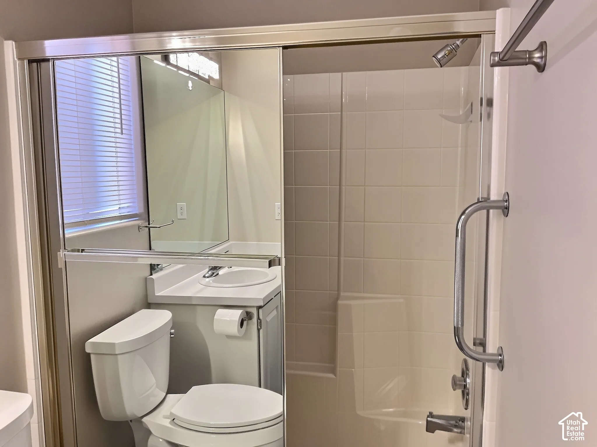 Built-in vanity with integrated sink, chrome faucet, and mirrored wall