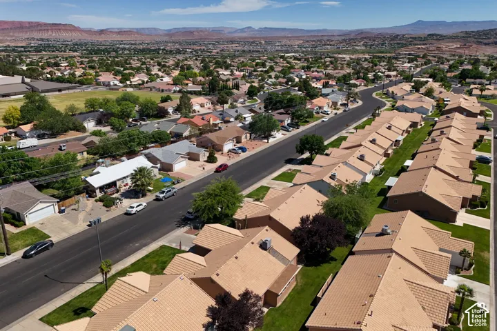 Established residential community featuring well-planned single-family homes with tan tile roofing, mature landscaping, and tree-lined streets
