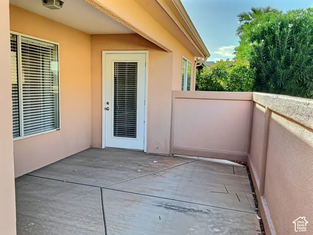Private patio with concrete flooring, covered ceiling, and exterior lighting