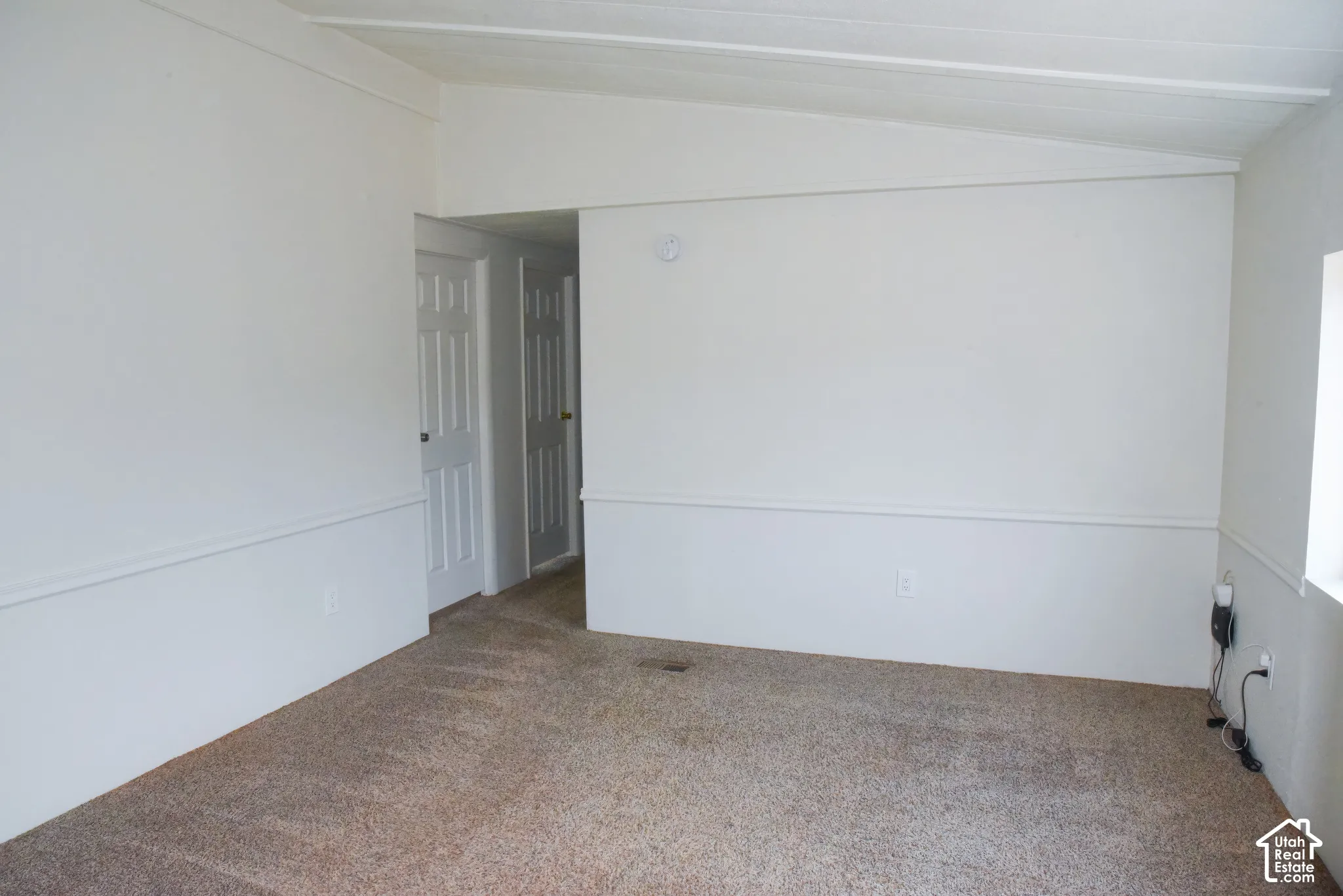 Neutral wall finishes, carpeted flooring, decorative wall trim, interior paneled doors, and a ceiling-mounted light fixture