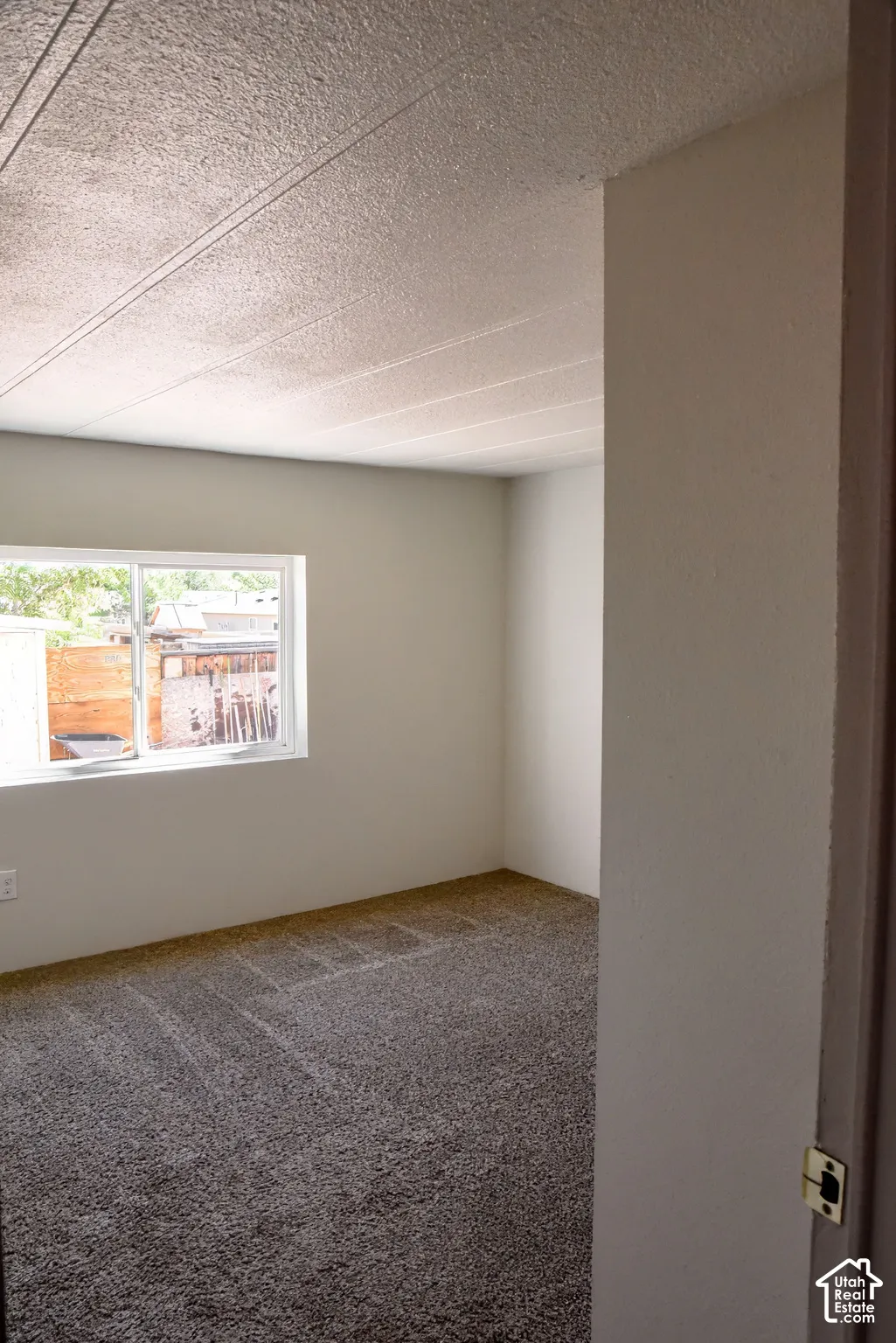 Neutral painted walls with a textured ceiling