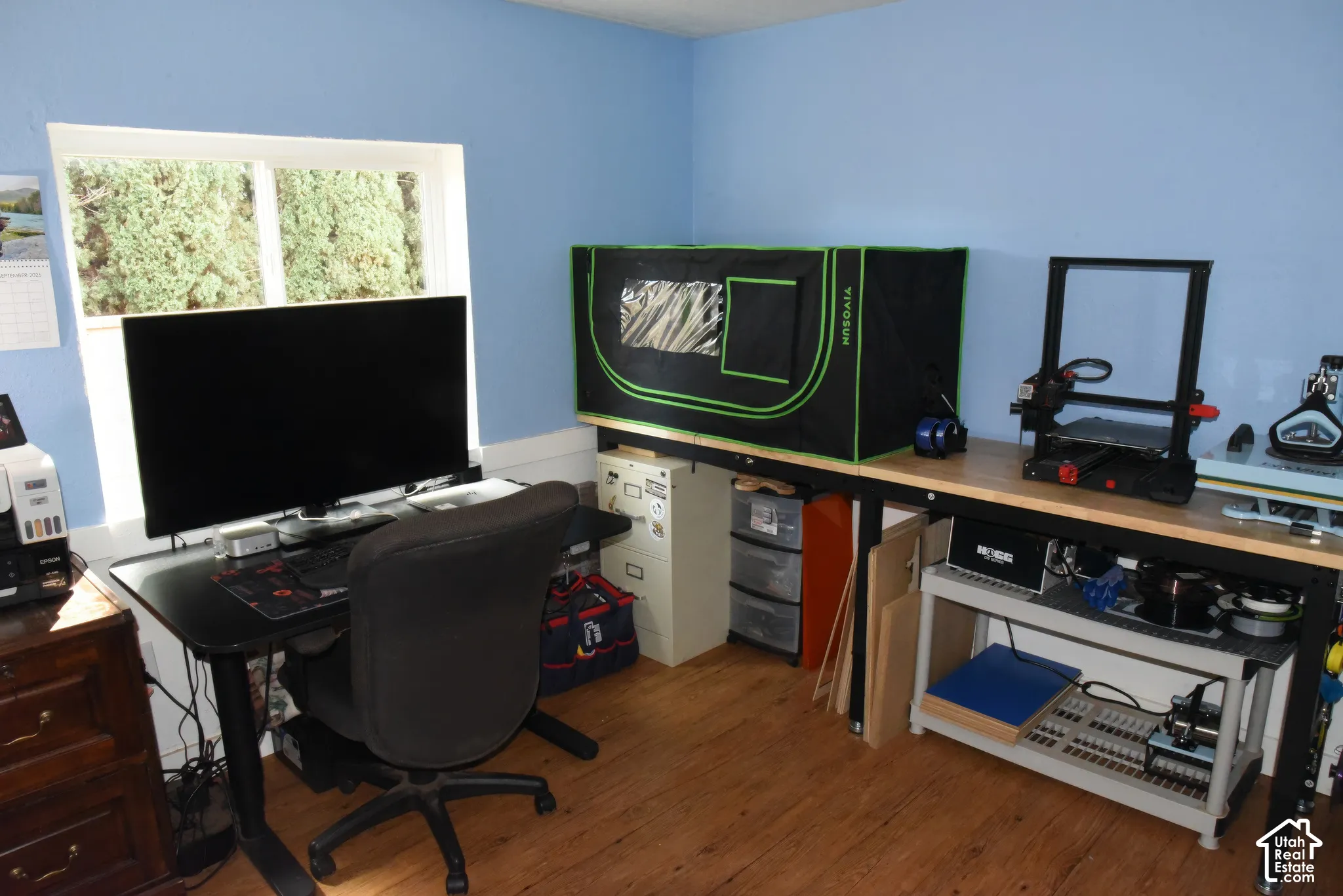 Hardwood-finish flooring, light blue wall paint, and white trim