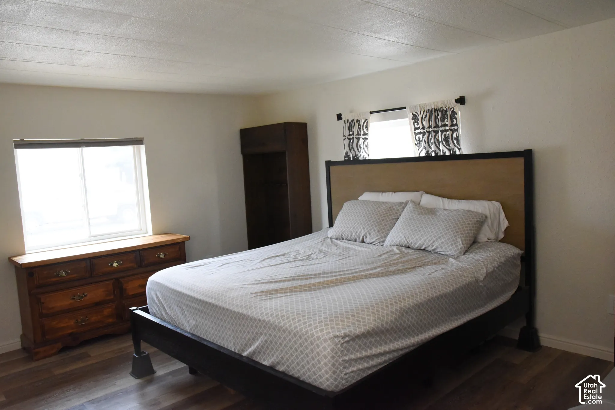 Wood-finish flooring with white baseboards and light-colored walls