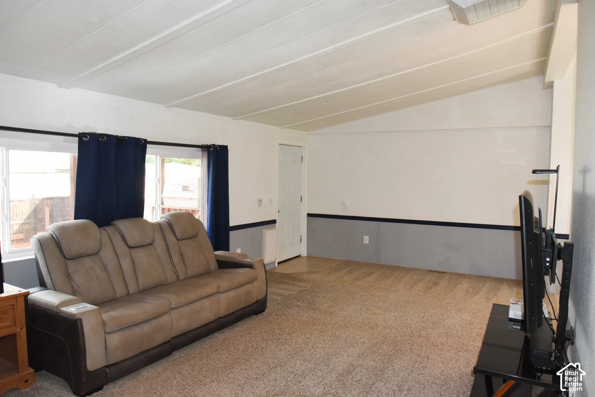 Vaulted ceiling with white paneling
