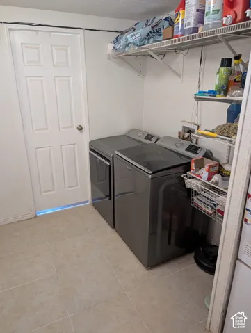 Dedicated utility area featuring tile flooring and built-in wire shelving