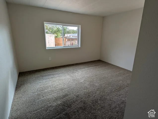 Light-colored walls and grey carpeting