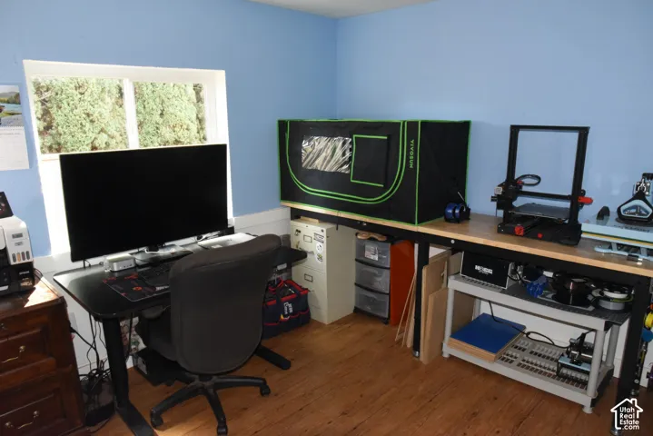 Hardwood-finish flooring, light blue wall paint, and white trim