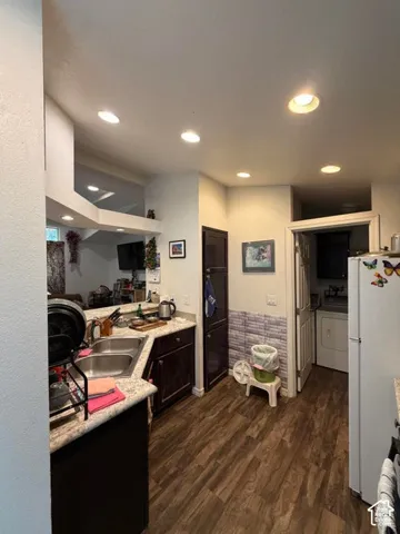 Kitchen featuring wood-finish flooring, recessed lighting, double basin sink, and built-in cabinetry