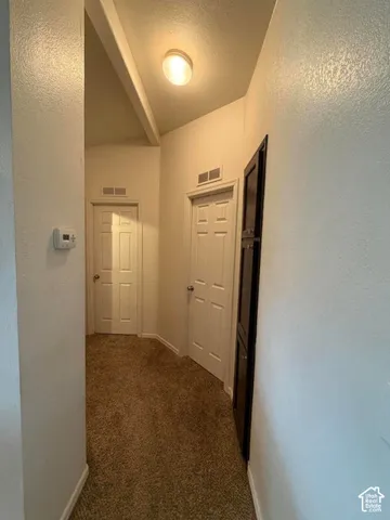 Vaulted ceiling with exposed beam and recessed lighting