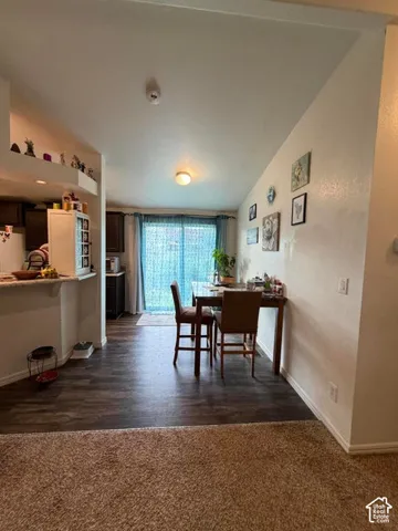 Wood-finish flooring extending from the kitchen area to the patio doors