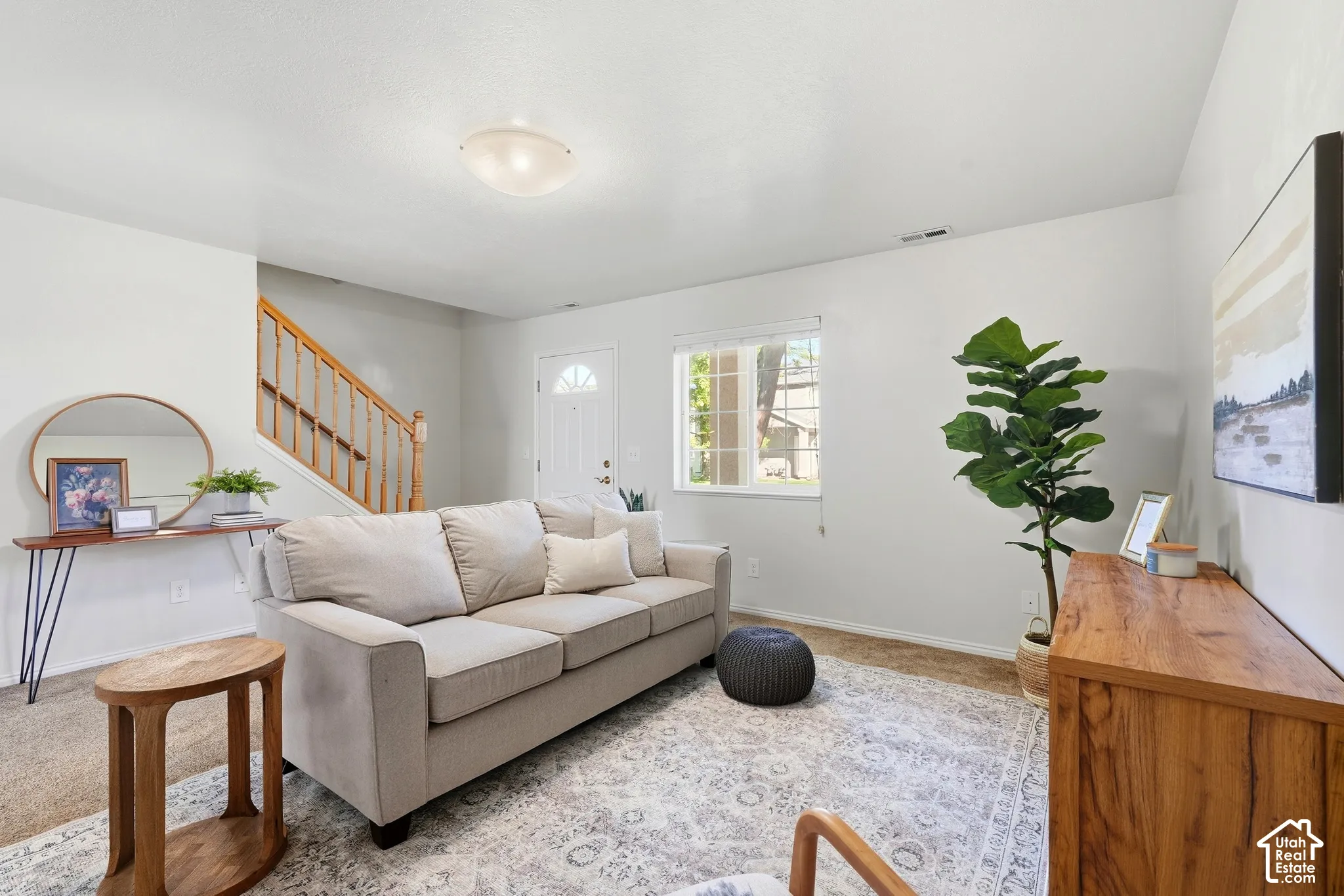 Inviting living space featuring a white entry door and a window with white trim