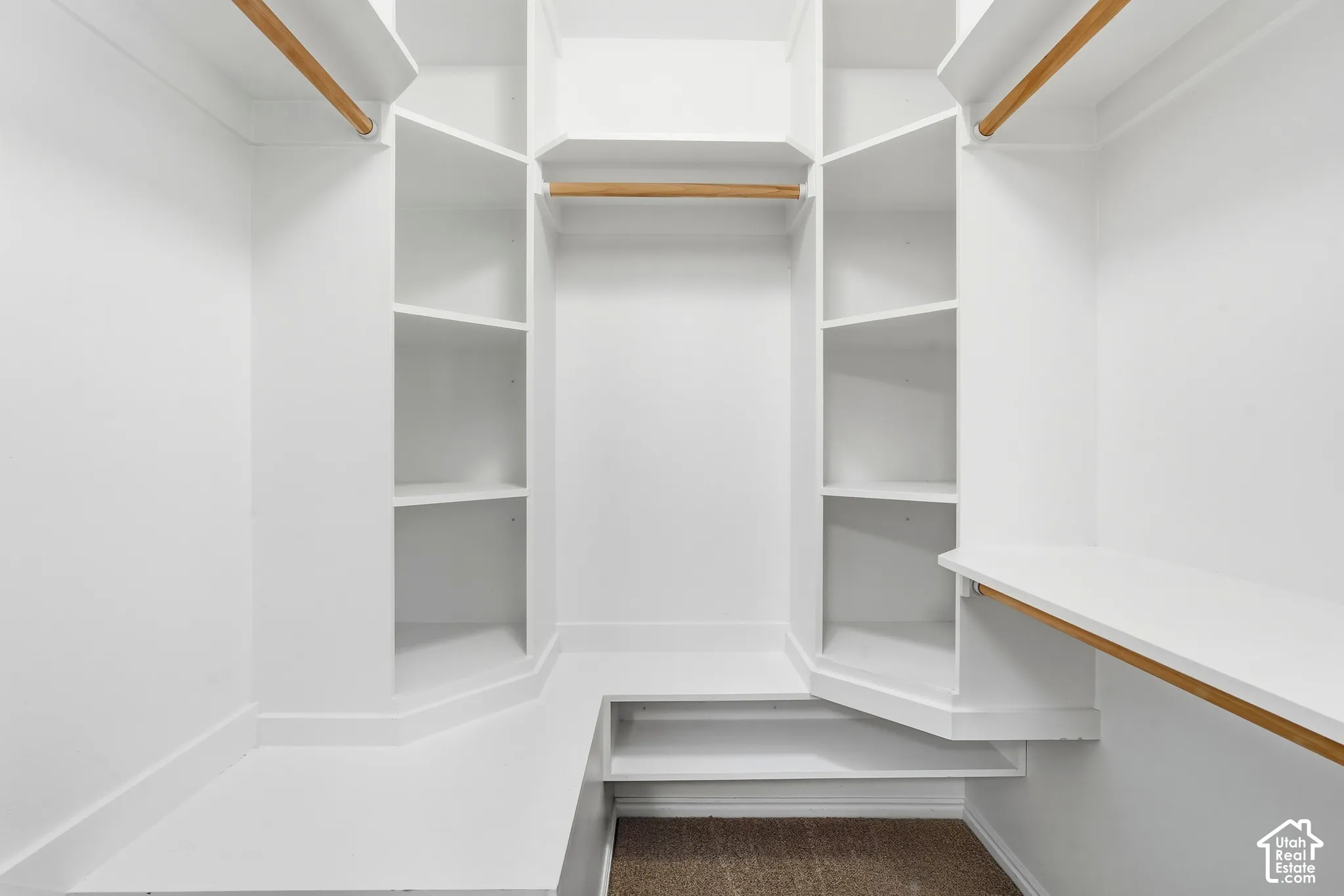 Custom-built closet system featuring multiple shelving units and hanging rods
