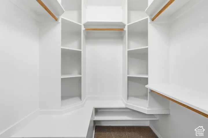 Custom-built closet system featuring multiple shelving units and hanging rods