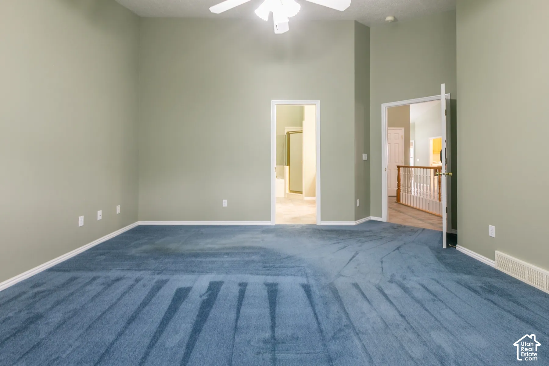 Interior space featuring vaulted ceilings, wall-to-wall carpeting, and a ceiling-mounted light fixture