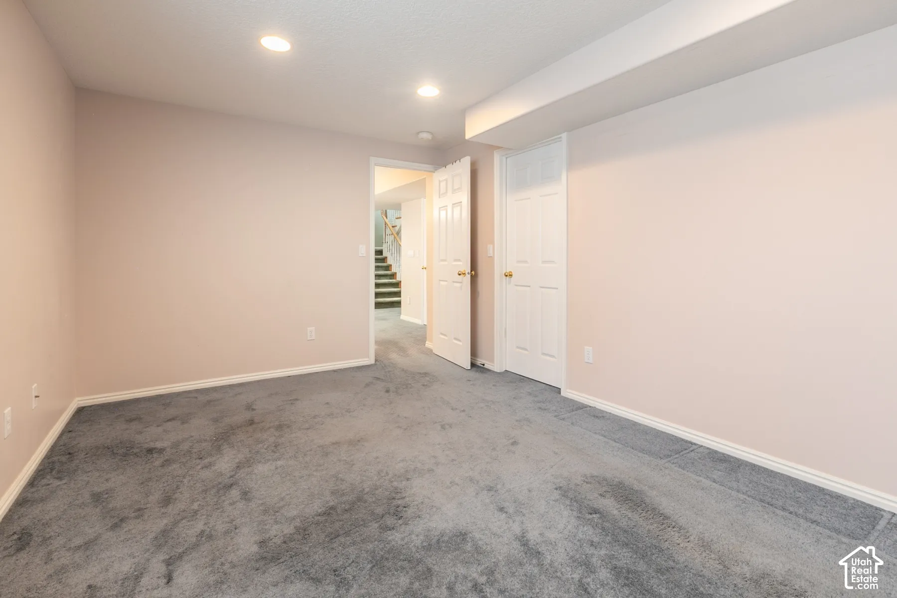 Room featuring neutral wall tones, carpeted flooring, and recessed ceiling lighting