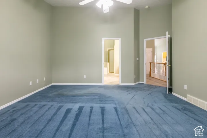 Interior space featuring vaulted ceilings, wall-to-wall carpeting, and a ceiling-mounted light fixture