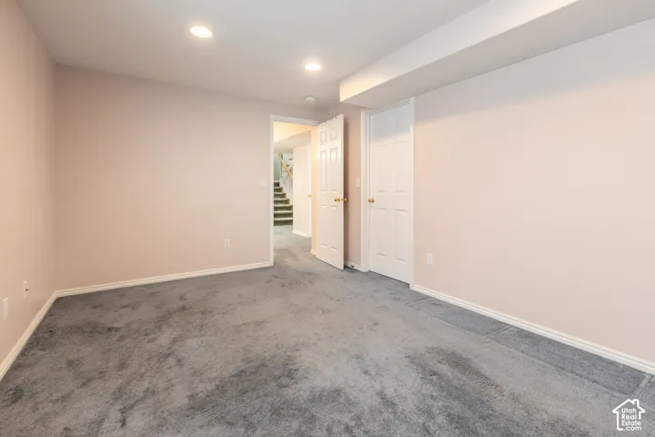 Room featuring neutral wall tones, carpeted flooring, and recessed ceiling lighting