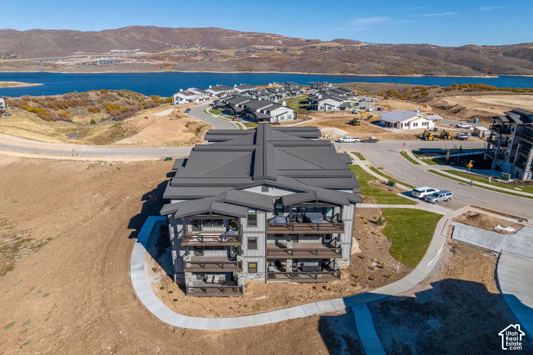 Contemporary multi-level building with dark grey siding and stone accents