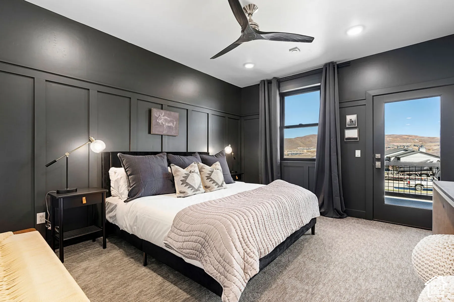Accent wall with paneling, ceiling fan with integrated lighting, recessed lighting, carpet flooring, and a glass-paneled door