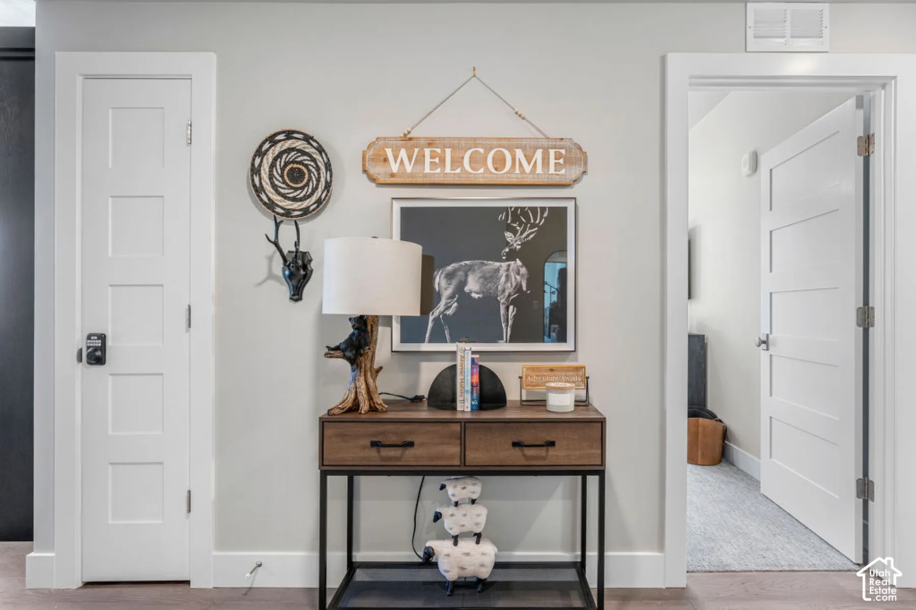 White five-panel interior doors, light gray wall paint, and wide white baseboards