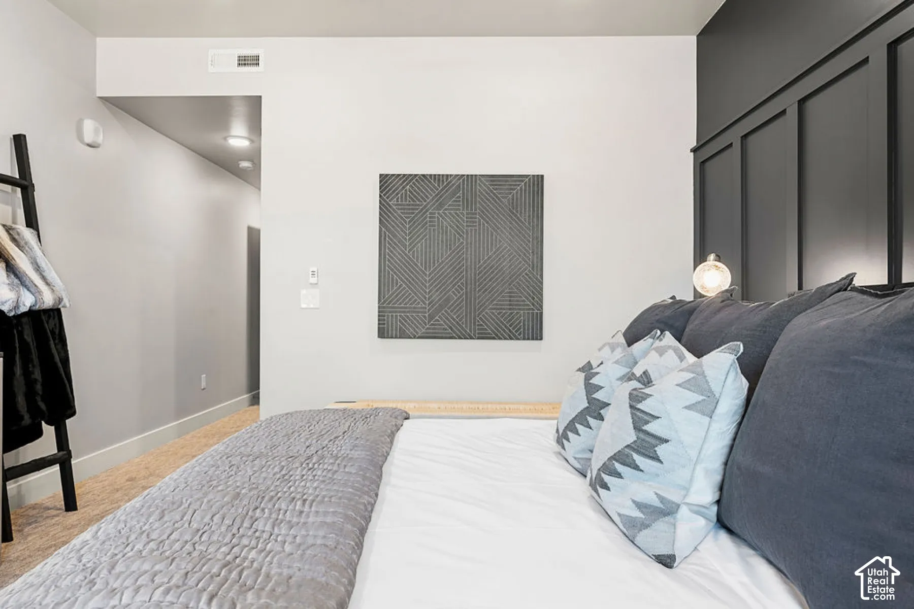 Accent wall with wainscoting detail, recessed lighting, and light wood-finish flooring