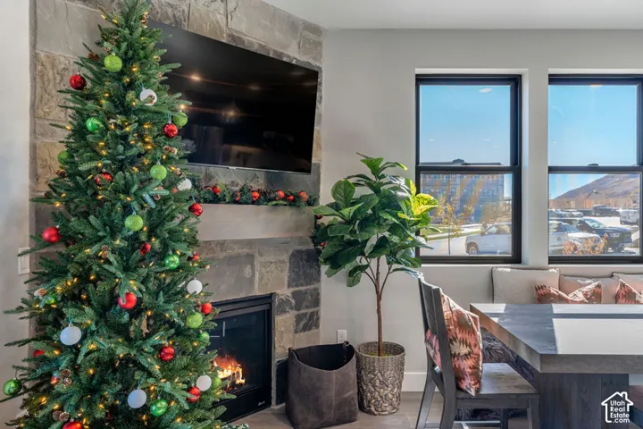 Stone-clad fireplace with a built-in mantel, a television recess, and a hearth
