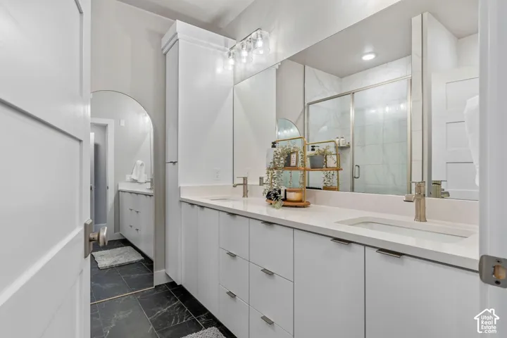 Dual vanity with undermount sinks, quartz countertops, and brushed nickel fixtures
