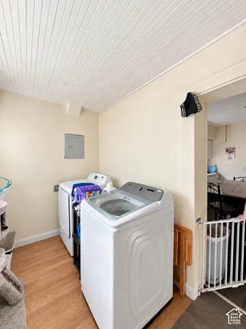 Laundry area featuring wood-finish flooring and a white plank ceiling