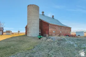 Red-sided barn with an attached silo and metal roof