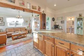 Kitchen island with wood-finish cabinetry and granite countertop